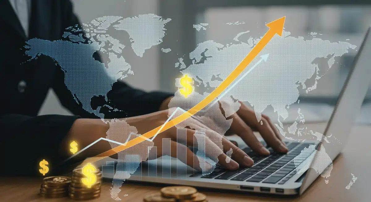 Money growth chart with dollar signs over US map, hands typing on laptop.