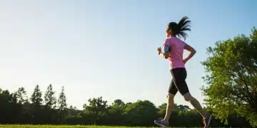 Person smiling during a morning run, reflecting improved mood from exercise.