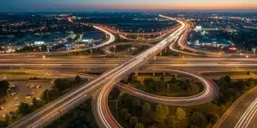 Modern highway interchange with streamlined traffic flow at sunset